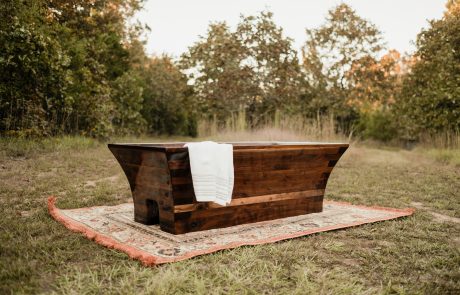 Black Walnut Tub positioned on a rug in a wooded field