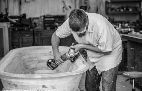 Taylor carving a bathtub in his workshop